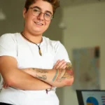 Confident transgender professional stands in modern office